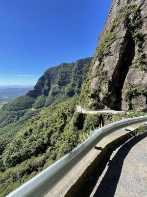 Estradas sinuosas às margens de montanhas na serra catarinense em dia ensolarado