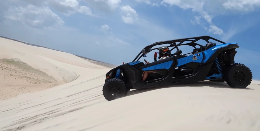 Carro off-road azul desce por duna de areia em Camocim