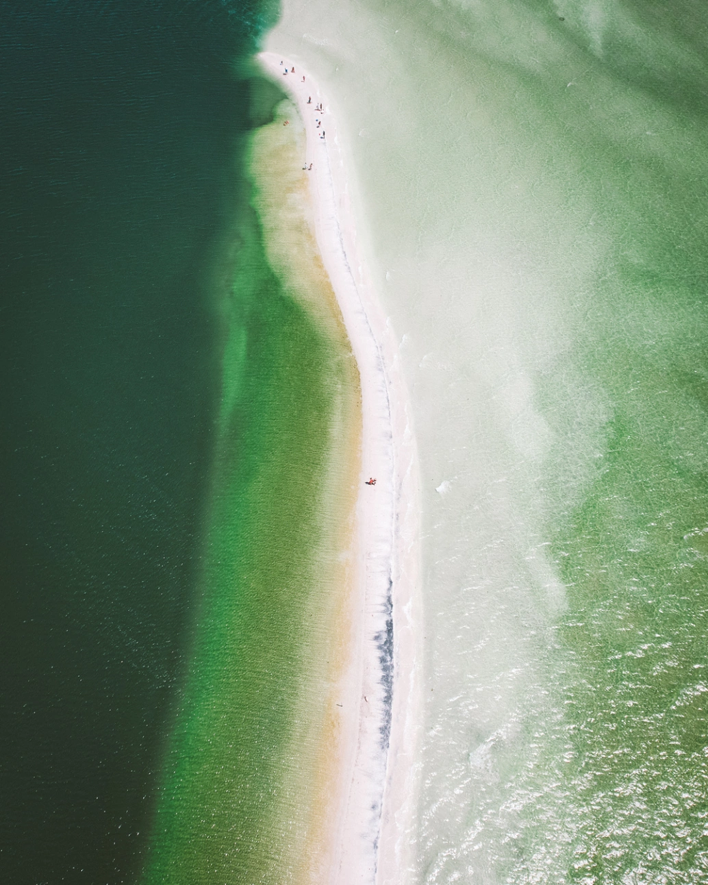 Vista aérea da Ponta da Alcaíra, Arraial do Cabo - RJ. Faixa de areia cria passeio em meio ao verde mar.
