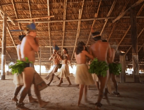 Indígenas dançam dentro de aldeia situada no Rio Negro