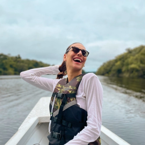 Mulher sorrindo à bordo de passeio de barco em rio